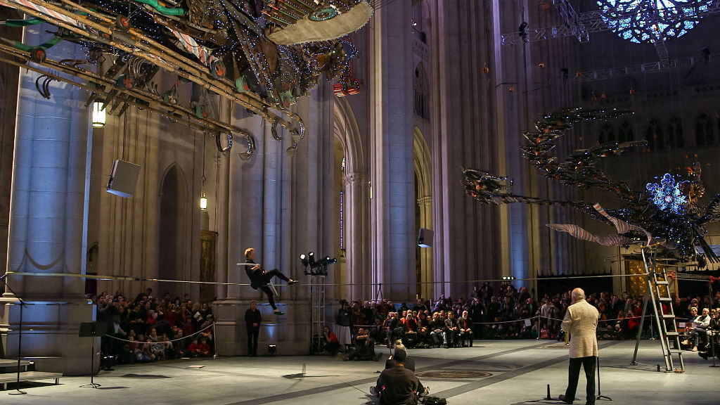 Image © Rhonda Dorsett; playing with wire artist Philippe Petit under Xu Bing's Pheonix sculptures, New York's Cathedral St. John the Divine, March 2014